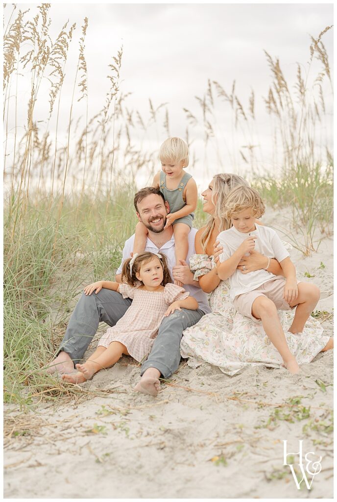 family sitting on the sand dunes taken by HWP, a Kittery, Maine family photographer