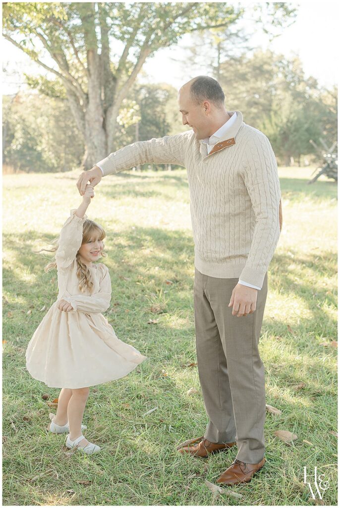 Dad twirling his daughter during an outdoor family session