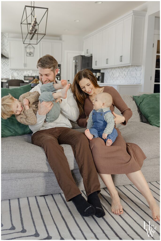 Family cuddling together during an in-home photos
