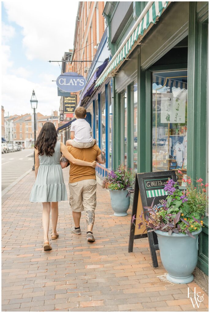 Family walking through downtown Portsmouth, NH with their son