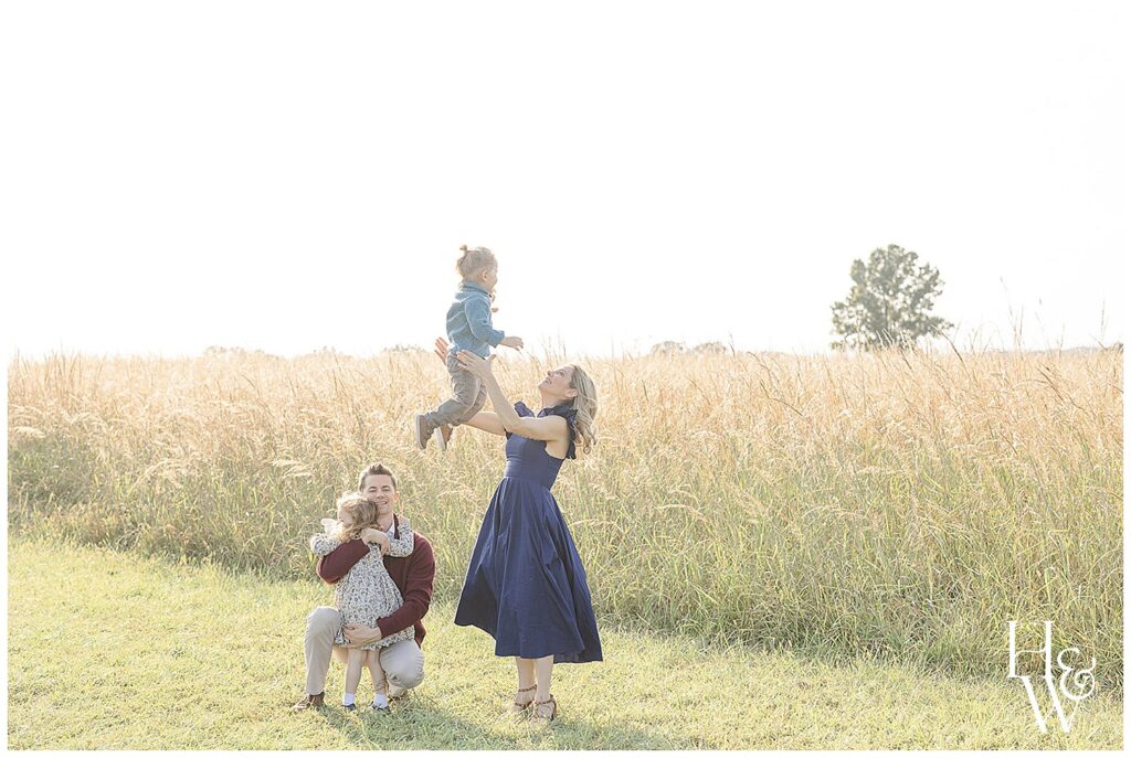 family in a field with tall grass during fall photos